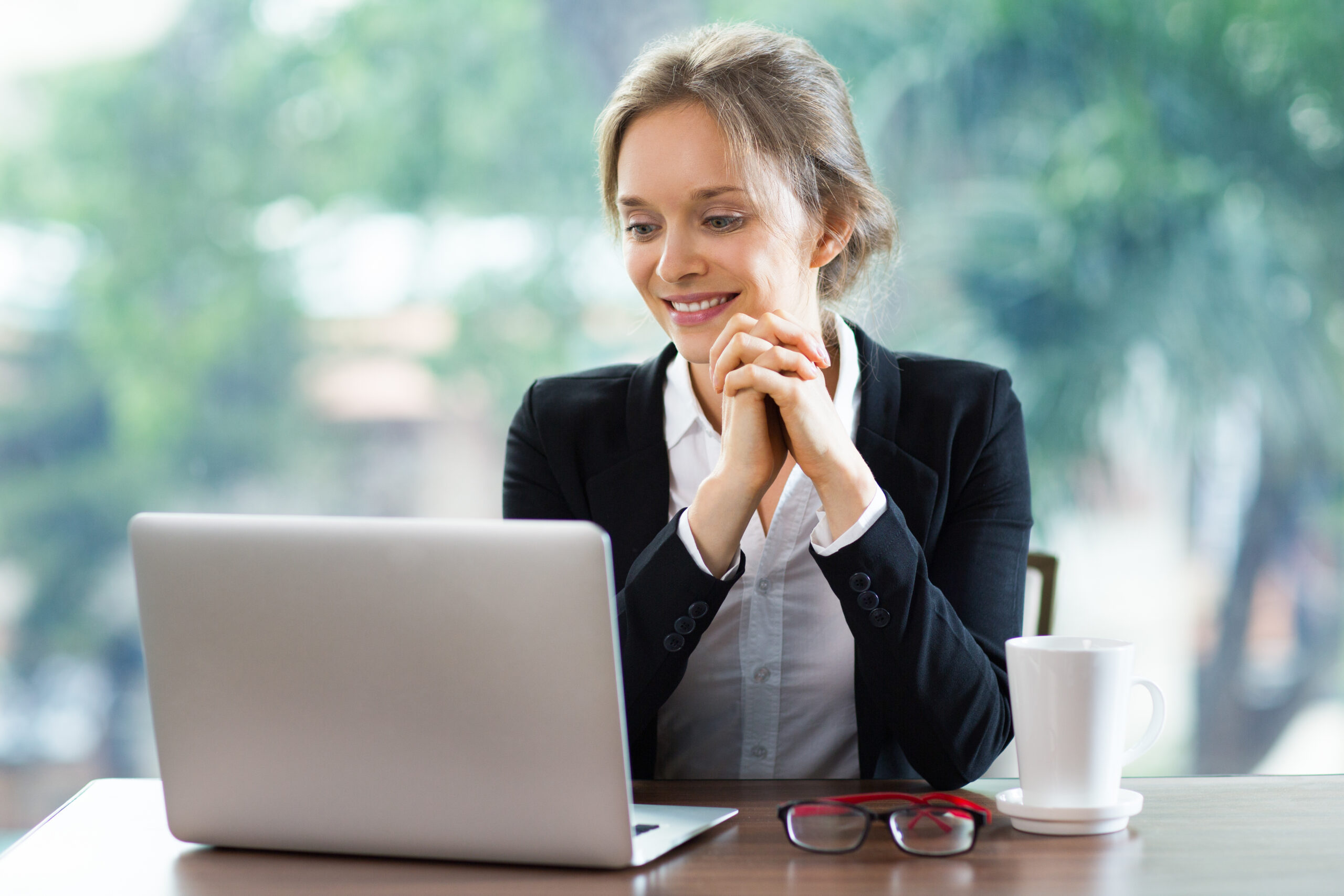 Happy Young Businesswoman with Laptop